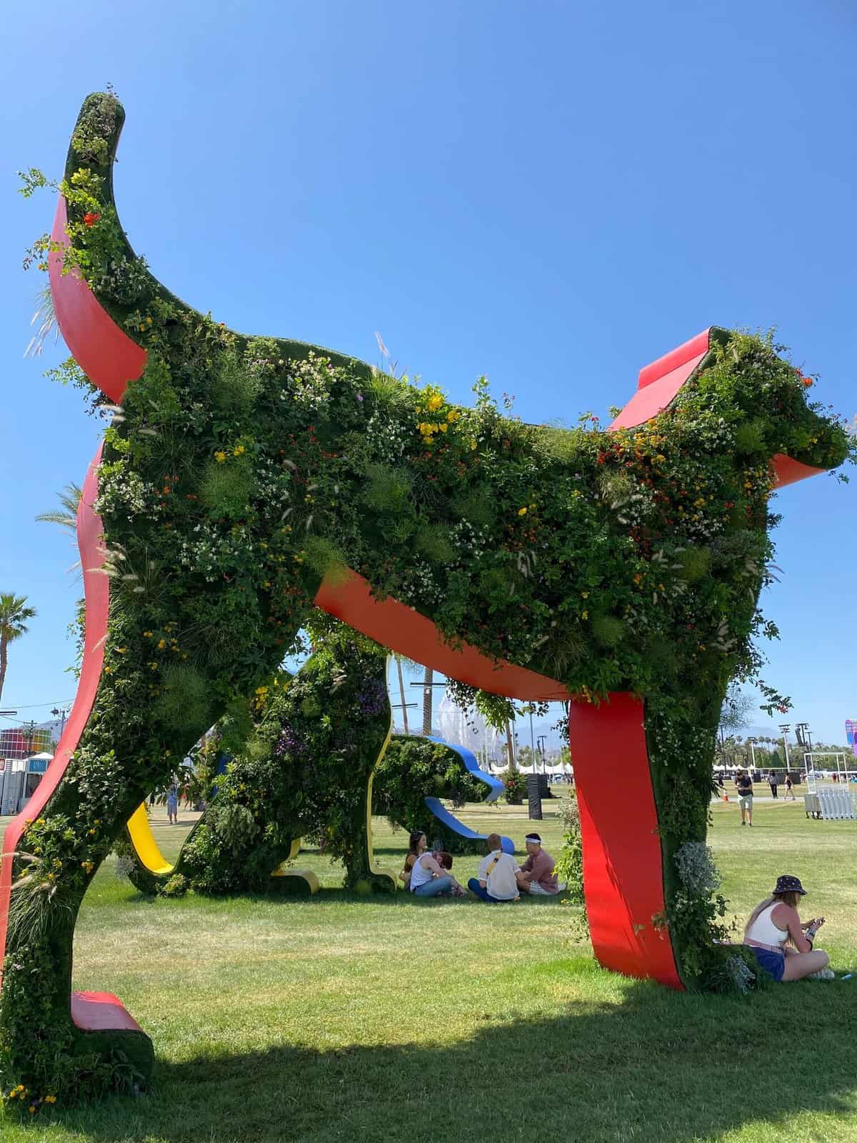 Dog art at Coachella dog standing in the sun metal and filled with ;plants.