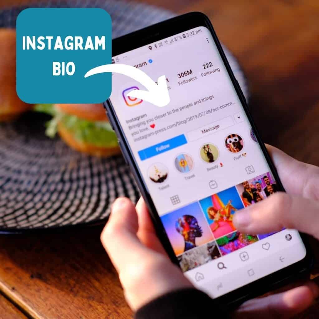 A picture on a phone being held by a person with a close up of an Instagram account showing where your Instagram bio should go.