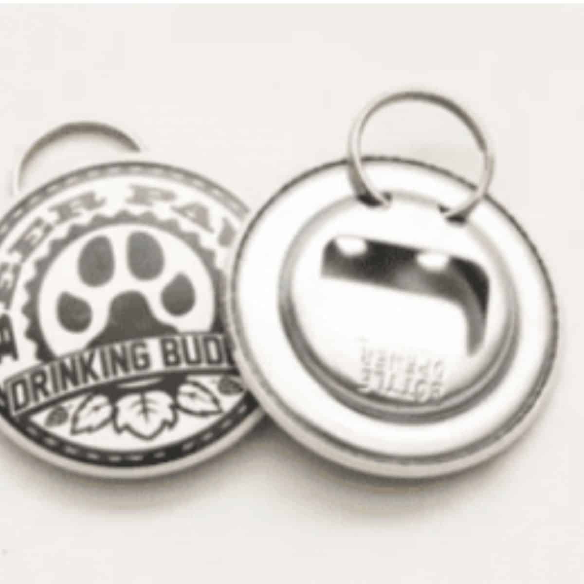 Small keychain bottle opener that is round and goes on a leash and says drinking buddy,