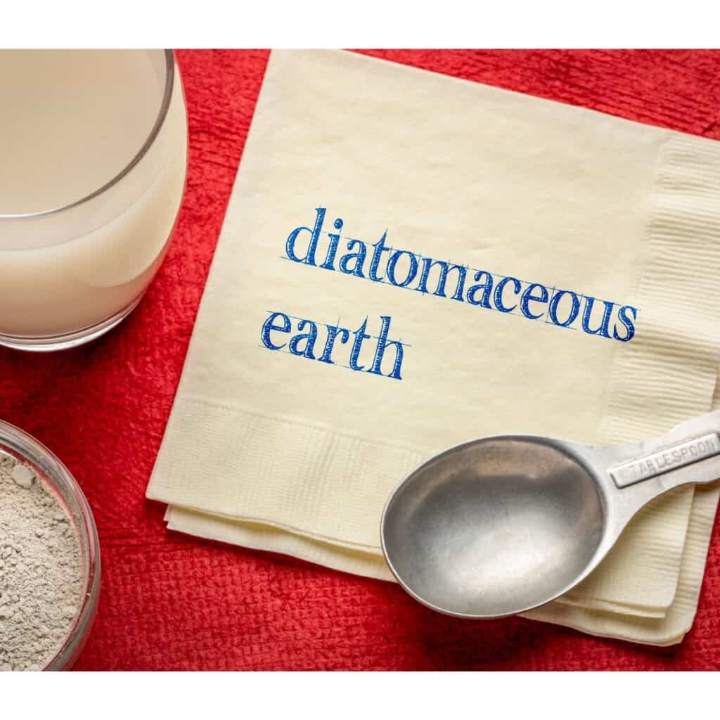 A picture of diatomaceous earth with a spoon and a cup of it dissolved.